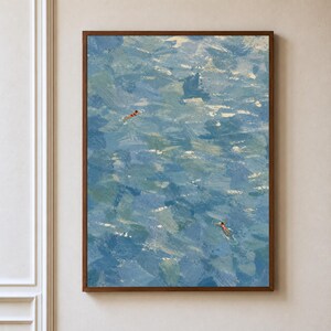 May include: A vertical rectangular wall art piece featuring an impressionistic oil painting of a deep blue and turquoise sea. Two small figures in red swimwear are visible swimming in the water, surrounded by thick, textured brushstrokes.