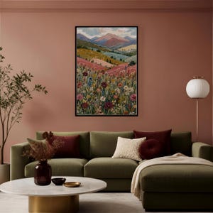 May include: A rectangular framed wall art print featuring a landscape painting of rolling hills, distant mountains, and a dense foreground of colorful wildflowers in shades of red, pink, yellow, and blue under a soft, cloudy sky.