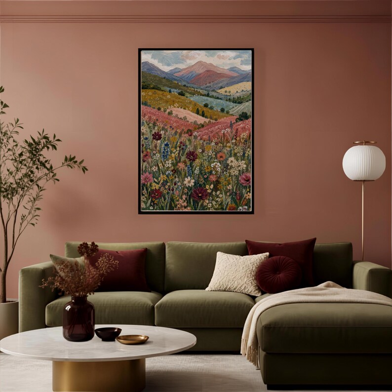 May include: A rectangular framed wall art print featuring a landscape painting of rolling hills, distant mountains, and a dense foreground of colorful wildflowers in shades of red, pink, yellow, and blue under a soft, cloudy sky.