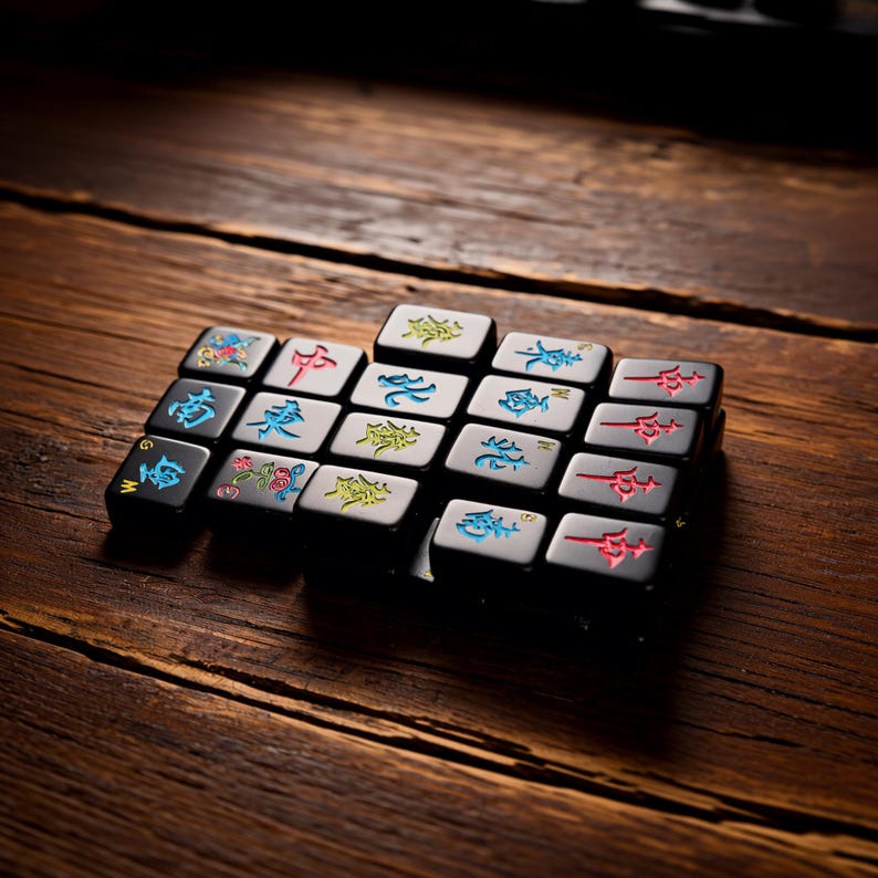 May include: A set of black mechanical keyboard keycaps arranged in a rectangular grid. Each keycap features engraved characters or symbols in vibrant red, blue, green, and yellow colors, including various Mahjong-style tiles and directional markers.