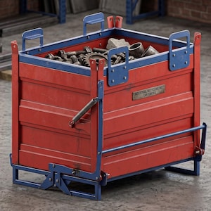 May include: A red and blue industrial metal storage bin with a rectangular frame, featuring a metal plate labelled INDUSTRIAL RECYCLING INC. CAP 1000 KG. The bin is filled with various metal hardware components, including gears, bolts, and cylindrical parts.