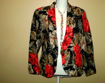 May include: A black velvet blazer with a floral pattern in shades of red, gold, and brown. The blazer has a shawl collar and a single button closure.