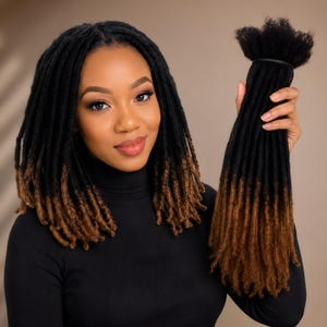 May include: A bundle of synthetic hair extensions featuring black roots that transition into a warm brown color at the ends. The hair is styled in textured, uniform locs with a matte finish, secured at the top with a black band for easy application.