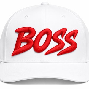 May include: A white baseball cap featuring the word BOSS embroidered in bold, raised red lettering across the front panels. The cap has a structured crown, a curved brim, and a button at the top center, showcasing a clean and simple design.