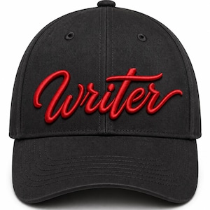 May include: A black baseball cap featuring the word Writer embroidered in a bold red script font across the front panels. The cap has a structured crown, a curved brim, and matching black stitching details throughout the fabric construction.