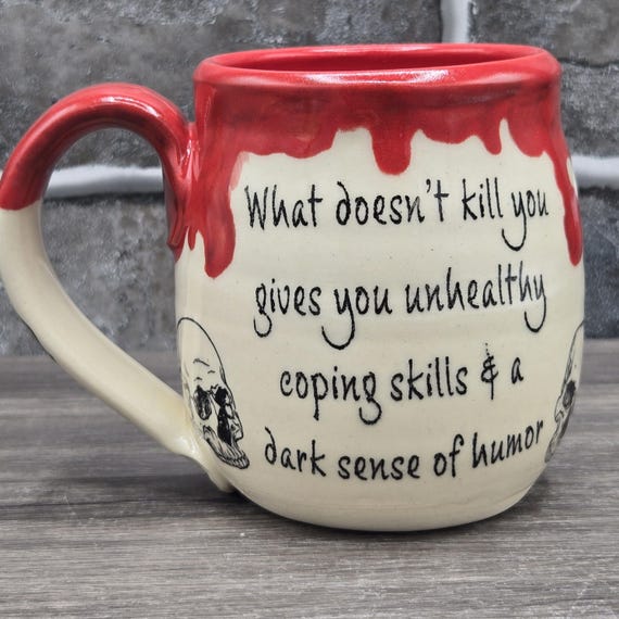 What Doesn't Kill You Affirmation mug, large mug, 14 oz. Skulls on the back of the mug. Red inside glaze