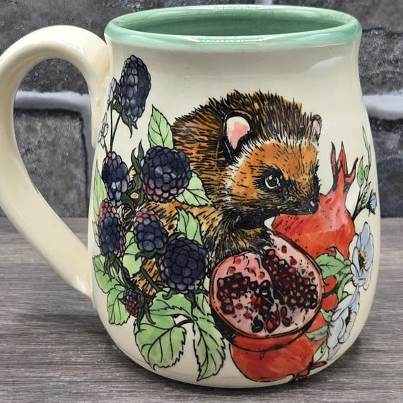 Hedgehog, pomegranate & blackberries mug, large mug ~14oz. Jade inside glaze. Dishwasher and microwave safe.