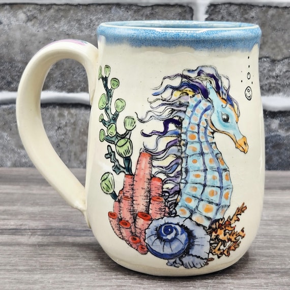 Seahorse mug with blue inside glaze. 16 oz. dishwasher and microwave safe.