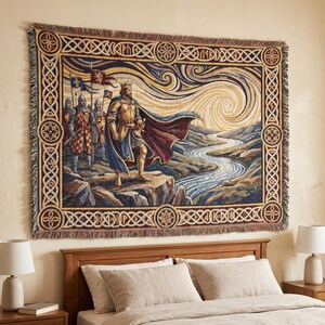 May include: A rectangular woven wall tapestry featuring a king in golden armour and a blue cape standing on a cliff overlooking a river. Three soldiers with flags stand behind the king. The scene is framed by a decorative border with Celtic knots.