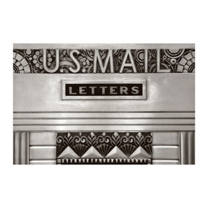May include: A vintage silver mailbox with the words "U.S. MAIL" and "LETTERS" embossed on it. The mailbox has decorative art deco designs.