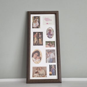 May include: A rectangular dark brown wooden collage picture frame with a white mat board containing eight various sized openings. The frame displays seven photographs of people and one rectangular card with the text North American Enclosures Inc.