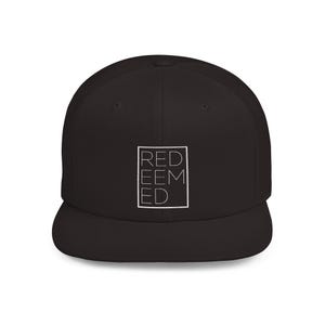 May include: A solid black baseball cap featuring a white embroidered square outline on the front panel. Inside the square, the word REDEEMED is stacked in three lines with the letters RED on the top, EEM in the middle, and ED on the bottom.