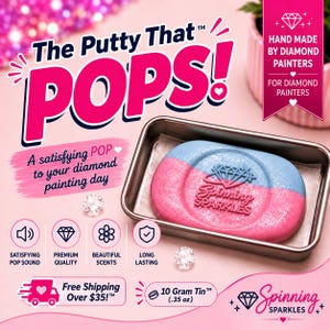 May include: A rectangular metal tin containing a dual-colored pink and blue putty with a diamond logo and the text Spinning Sparkles embossed on the surface. The putty is accompanied by two small clear faceted gems on a pink background with text.