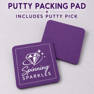May include: Two square purple putty packing pads. One pad features a white graphic of a diamond with sparkles and the text "Spinning SPARKLES". The top of the image includes the text "PUTTY PACKING PAD" and "INCLUDES PUTTY PICK".