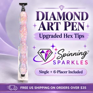 May include: A diamond art pen with a glittery, light pink and iridescent textured handle, featuring a silver metal tip and top. The text reads DIAMOND ART PEN, Upgraded Hex Tips, Spinning SPARKLES, and Single + 6-Placer Included.