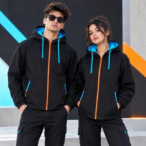 May include: Two matching black hooded jackets featuring a bright orange front zipper, vibrant blue hood lining, and matching blue drawstring cords. Each jacket includes two side pockets with blue accents and is paired with black cargo pants.