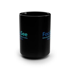 May include: A black ceramic mug featuring the word FocuSee in blue and teal lettering, accompanied by the text Write the vision and make it plain and the citation Habakkuk 2:2 printed in a smaller blue font on the side of the cylindrical vessel.