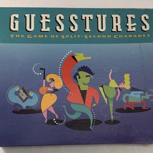 May include: A rectangular board game box titled GUESSTURES THE GAME OF SPLIT-SECOND CHARADES. The box features a blue background with stylized, colorful illustrations of four figures in dynamic poses, including a central green figure in a red jacket.