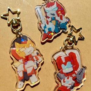 Porte-clés Transformers Delphi Medics en acrylique holographique - Pharma, Ambulon, Premiers secours