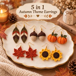 May include: A set of five pairs of crochet earrings on a white scalloped plate, featuring designs of leaves, acorns, pumpkins, and sunflowers in autumn colours. The text 5 in 1 Autumn Theme Earrings is displayed above the jewellery on a decorative sign.