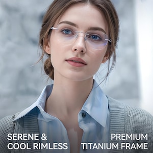 May include: Rimless eyeglasses featuring a silver-toned titanium frame with thin temples and clear lenses. The text SERENE & COOL RIMLESS PREMIUM TITANIUM FRAME is displayed at the bottom of the image in white capital letters.