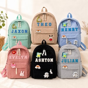 May include: Six corduroy backpacks in mint, tan, blue, pink, black, and gray. Each bag features a front pocket, a top handle, and personalized names: Jaxon, Theo, Henry, Evelyn, Ashton, and Julian. Decorative patches include rainbows, animals, and astronauts.