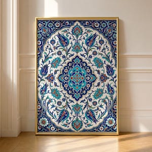 May include: A rectangular wall art print featuring a symmetrical floral pattern with intricate blue, turquoise, and red motifs on a white background, encased in a thin gold frame. The design displays stylized tulips and vines in a repeating layout.