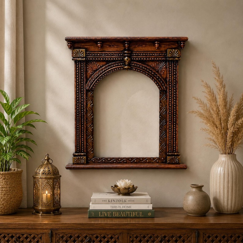 May include: A rectangular wall mirror featuring a dark brown wooden frame with an arched top, intricate carved detailing, and gold-toned accents. The frame includes a small shelf at the base and decorative columns on both sides of the central glass.