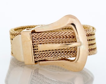 May include: A gold-toned ring with a woven chain design and a buckle closure.