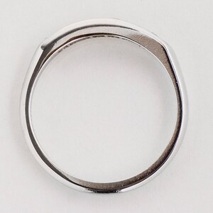 May include: A silver band ring with a smooth, polished finish.
