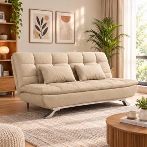 May include: A beige tufted sofa bed featuring a rectangular backrest and seat cushion with a grid pattern. The sofa includes two matching rectangular throw pillows and is supported by four silver-toned metal legs with a curved, angled design.