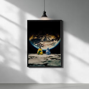 May include: A rectangular wall art print featuring two figures sitting on a gray, cratered lunar surface. They are looking up at a large, glowing Earth suspended in the dark void of space. The figure on the left wears a yellow jacket, while the figure on the right wears a blue and white outfit.