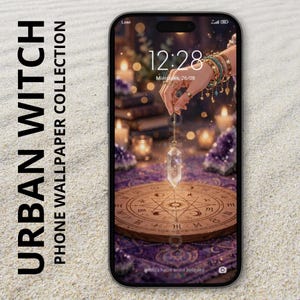 May include: A smartphone displaying a digital wallpaper titled URBAN WITCH PHONE WALLPAPER COLLECTION. The screen shows a hand holding a clear crystal pendulum over a circular wooden board with astrological symbols, surrounded by purple crystals.