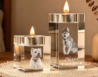 May include: Two clear rectangular glass candle holders with lit tea lights. The smaller holder features a white dog, while the taller one displays a husky, the name Narla, the years 2018-2026, and two paw print icons etched into the glass surface.