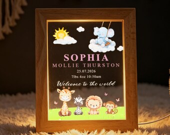 May include: A rectangular wooden light box featuring a personalized birth announcement for Sophia Mollie Thurston. The design includes a blue elephant on a cloud, a yellow sun, and safari animals like a giraffe, zebra, lion, and monkey on green grass.