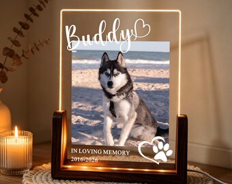 May include: A rectangular acrylic memorial plaque with a wooden base featuring an illuminated edge. The plaque displays a photograph of a husky dog on a beach, the name Buddy, a heart icon, the text IN LOVING MEMORY, and the years 2016-2026.