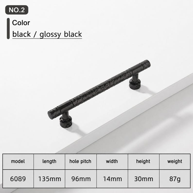 May include: A glossy black cabinet handle with a textured, hammered surface. The handle is model 6089, measuring 135mm in length, 14mm in width, and 30mm in height, with a 96mm hole pitch and a weight of 87g. The text NO.2 and black / glossy black appear.