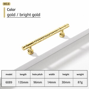 May include: A bright gold cabinet handle with a textured, hammered surface. The handle is model 6089, measuring 135mm in length, 96mm hole pitch, 14mm width, 30mm height, and weighing 87g. The text NO.6 and Color gold / bright gold are visible.