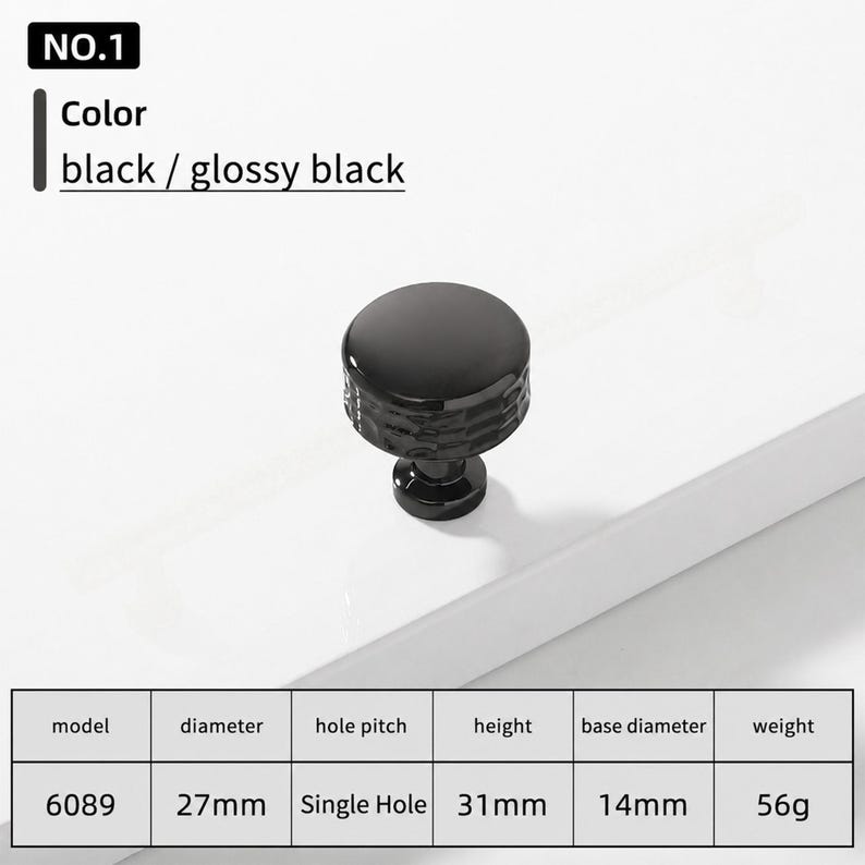 May include: A glossy black cabinet knob, model 6089, featuring a round top and a textured side. The knob has a 27mm diameter, 31mm height, 14mm base diameter, and weighs 56g. It is a single hole installation piece with a smooth, reflective finish.
