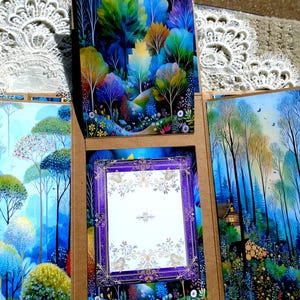 May include: A multi-panel greeting card featuring vibrant watercolor illustrations of colorful trees and forest scenes. The central panel has a purple and gold ornate frame with a blank white space for a message. The card is open, revealing the artwork.