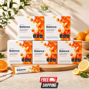 May include: Five white boxes of Unicity Balance dietary supplement drink mix with orange geometric patterns. Each box displays the text The smart solution to balanced nutrition, Natural Orange Flavor, 4g fiber, 0g sugar, and 30 stick packs. A single stick pack is placed in front.