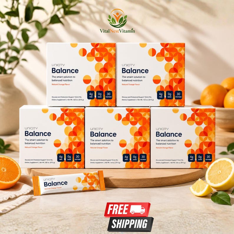 May include: Five white boxes of Unicity Balance dietary supplement drink mix with orange geometric patterns. Each box displays the text The smart solution to balanced nutrition, Natural Orange Flavor, 4g fiber, 0g sugar, and 30 stick packs. A single stick pack is placed in front.
