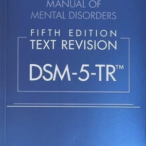 May include: A blue book cover titled DIAGNOSTIC AND STATISTICAL MANUAL OF MENTAL DISORDERS FIFTH EDITION TEXT REVISION DSM-5-TR with the text AMERICAN PSYCHIATRIC ASSOCIATION at the bottom. The cover features white text on a solid blue background.
