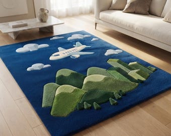 May include: A rectangular area rug featuring a deep blue background with a three-dimensional tufted design. The rug displays a light-coloured aeroplane flying above green rolling hills and small trees, accented by white clouds scattered across the sky.