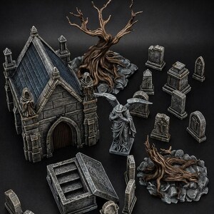 Op de afbeelding: Een miniatuur begraafplaatsset met een stenen mausoleum met een donker dak, een wenend engelbeeld, een open stenen sarcofaag, twee knoestige bruine bomen en diverse grijze grafstenen en grafmarkeringen op een donkere ondergrond.