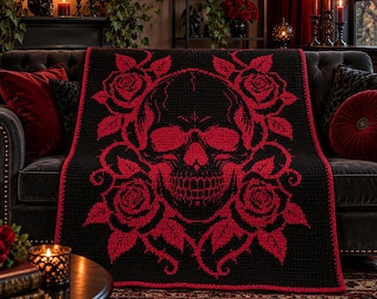 May include: A rectangular crochet blanket featuring a large, central human skull motif in vibrant red yarn against a solid black background. The skull is surrounded by detailed red rose blossoms and thorny vines, with a matching red border edge.