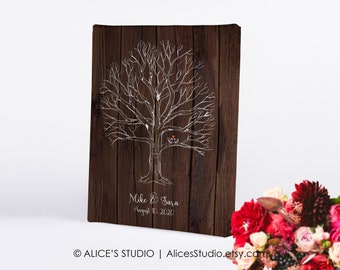 May include: A rustic wooden canvas print with a white silhouette of a tree with branches. The tree has two small birds in the branches and a heart at the base of the trunk. The text "Mike & Sara August 10, 2020" is written below the tree.