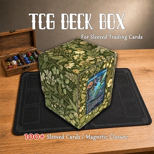 May include: A square TCG deck box featuring a green botanical print with various flowers and leaves. The front displays a single trading card in a clear window. The box includes a magnetic closure and holds 100+ sleeved trading cards.