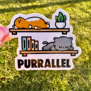 May include: A white sticker with a black and white illustration of two cats sleeping on shelves. The shelves have books and a potted plant. The text "Purr-allel" is below the shelves.