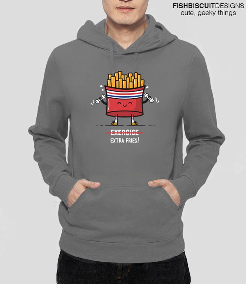 May include: A gray hoodie with a cartoon image of a french fry container holding dumbbells. The container has a smiling face and the text "EXERCISE EXTRA FRIES!" is printed below the image.